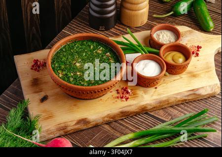 Traditional Russian okroshka soup with fresh condiments Stock Photo