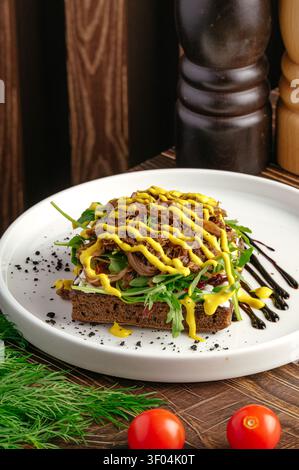 Gourmet open face sandwich with pulled meat and mustard Stock Photo
