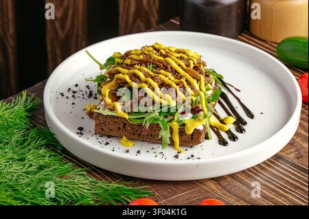 Gourmet pulled meat toast with mustard and arugula Stock Photo