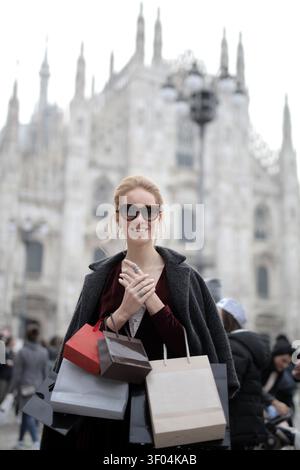 Happy young woman shopping in Milan Italy Stock Photo