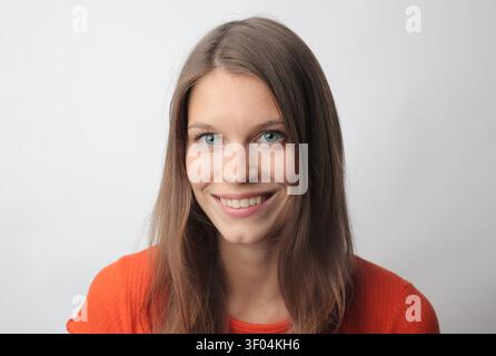 Happy young woman with blue eyes smiling at camera Stock Photo