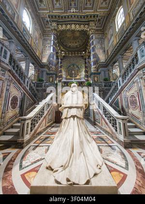 The marble monument to Pope Pius IX seen from behind, standing at the top of the Confessio staircase inside the Basilica of Santa Maria Maggiore in Ro Stock Photo