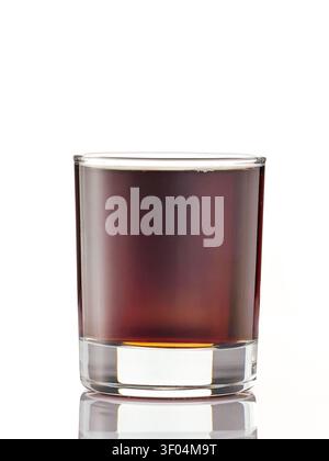 Glass of dark soda or liquor on white background Stock Photo