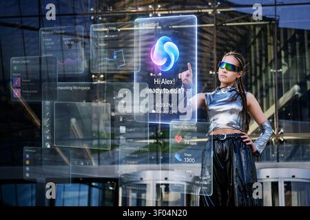 Young woman interacts with futuristic holographic AI display Stock Photo