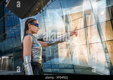 Young woman interacts with augmented reality screen Stock Photo