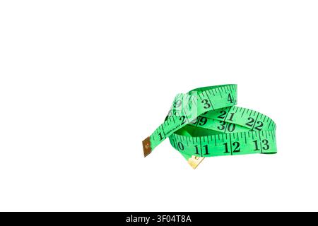 Green Flexible Measuring Tape Curled with Inch Numbers Isolated on White Background Stock Photo