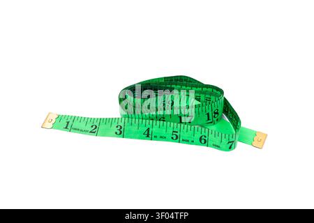 Coiled Green Measuring Tape Showing Centimeter and Inch Numbers Isolated on White Background. Stock Photo