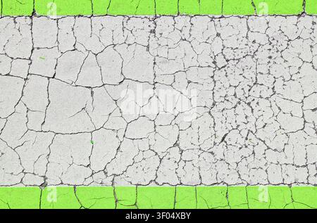 Cracked paint background. Green frame border and white weathered surface. Blank copyspace grunge banner. Stock Photo