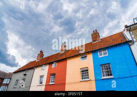 Colourful terraced houses in Cromer in North Norfolk, UK on a cloudy grey sky day Stock Photo