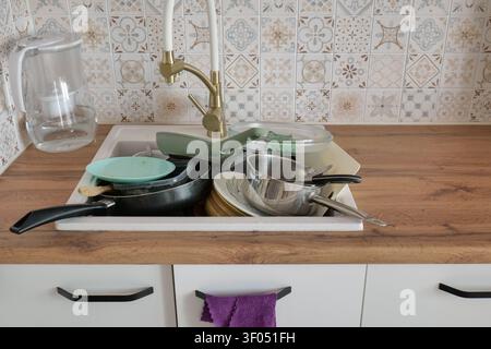 Pile of Dirty Dishes in Kitchen Sink Stock Photo
