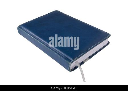 Old worn diary with blue faux leather cover, stitched edges and silver ribbon bookmark, isolated on white background. Vintage planner for organization Stock Photo