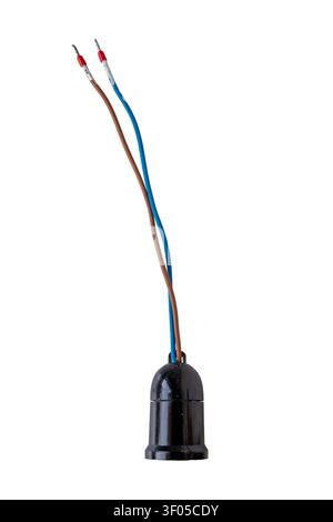 Old used black plastic light bulb socket with cracks, white paint splashes and exposed blue and brown wires, isolated on white background. Stock Photo