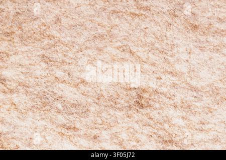 Horizontal macro top view shot of a dense beige and light brown wool felt texture fabric surface with a chaotic organic fiber structure pattern detail Stock Photo