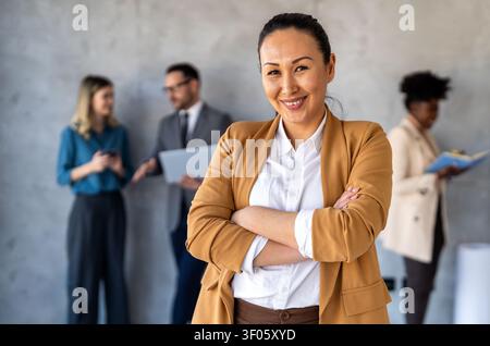 Multicultural professional businesspeople working together on research plan in boardroom. Stock Photo