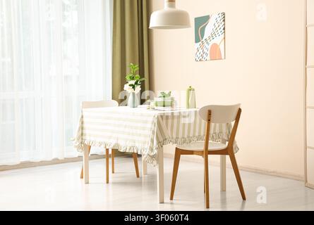 Bright dining room with table set and modern chairs Stock Photo