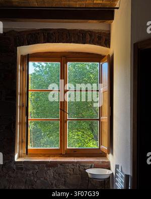 Rustic cottage window opening to green nature view Stock Photo