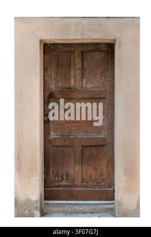 A weathered and rustic dark brown wooden door with a five-panel design set into an old beige stucco wall, showing beautiful natural grain texture and Stock Photo