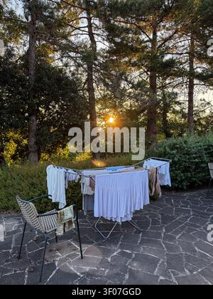Laundry drying on rack outdoors at sunset Stock Photo