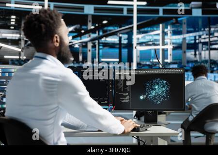 System administrator works with computer in a data center to support data processing, analytics, and storage infrastructure. Stock Photo