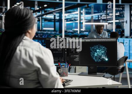 Computer scientist uses machine learning algorithms in a server room to analyze datasets and recognize data patterns. Stock Photo