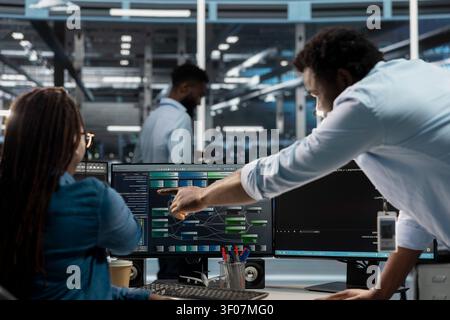 Data center manager reviews node tree software to analyze datasets and improve server infrastructure performance. Stock Photo
