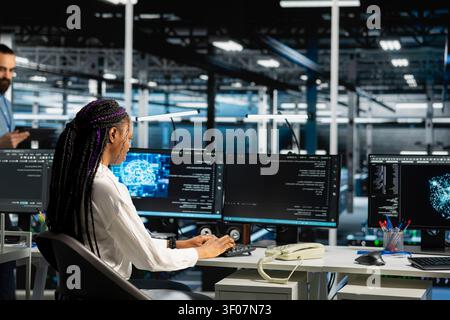 Software engineer working in server environment with hardware supporting data mining. Stock Photo