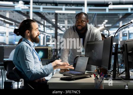 Team of workstation scientists working with workstation in server environment, analyzing data. Stock Photo