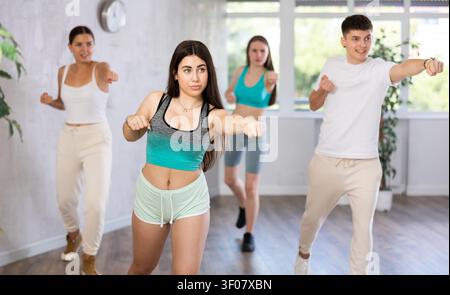 Teenagers practicing breakdance toprock moves in training hall. Teenagers engaged in breakdance Stock Photo