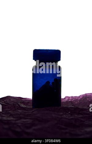 Blue Medicine Bottle Silhouette With Screw Cap Standing On Crumpled Purple Tissue Against White Backlight Creating Shadowy Minimal Studio Product Composition. Stock Photo