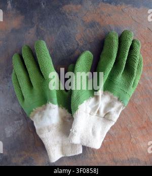 A Pair of Used Garden (Work) Gloves on a Rustic Slate Background Stock Photo