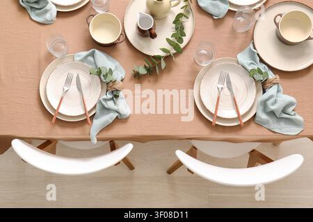 Minimalist dining table set for two with natural decor Stock Photo
