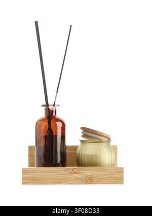 Aromatic reed diffuser and scented candle on wooden tray Stock Photo
