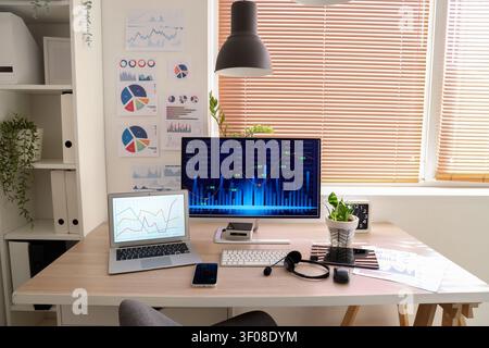 Data scientists workplace with computer and diagrams in office Stock Photo