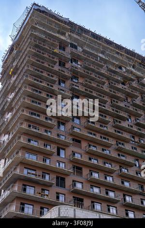 Abstract close up of a high rise concrete building facade under construction. Concept: Modern architectural geometry and rhythm Stock Photo