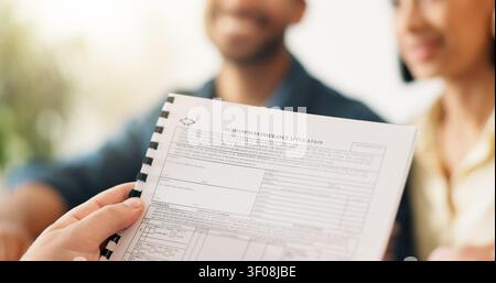 Hands, realtor and reading document with couple, finance advice and application for real estate. Smile, people or advisor with paperwork, financial Stock Photo