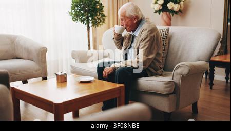 Senior, man and drinking tea in nursing home with thinking, peaceful moment or daydream of past history. Calm, elderly person and relax in retirement Stock Photo