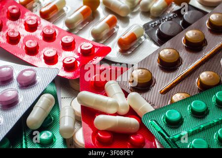 Various medical pills close-up. Colorful tablets, pills and capsules in blister packs. Stock Photo