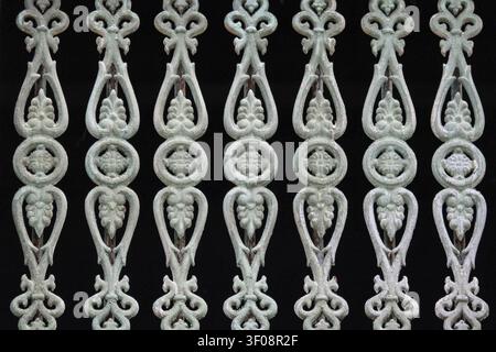 Close-up of an ornate cast iron railing featuring symmetrical floral and geometric patterns in a historic heritage house in George Town, Penang, Malay Stock Photo