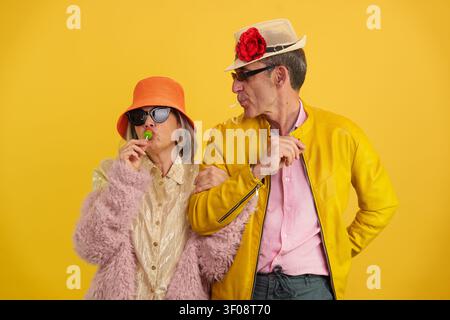 Mature couple enjoying lollipops and having fun Stock Photo
