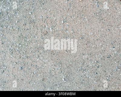 High-resolution top view of a light gravel and dirt surface with small stones. Natural textured background with ample copy space, ideal for graphic de Stock Photo