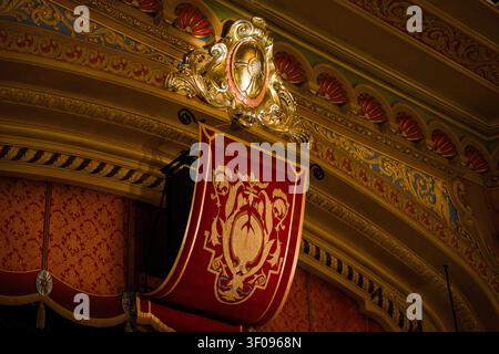 Red Velvet Drape With Gold Crest Emblem On Theater Balcony Box Stock Photo