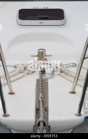 serene anchor secured on boat deck with white and blue rope and chain close-up view of marine equipment in natural light clean background editorial Stock Photo