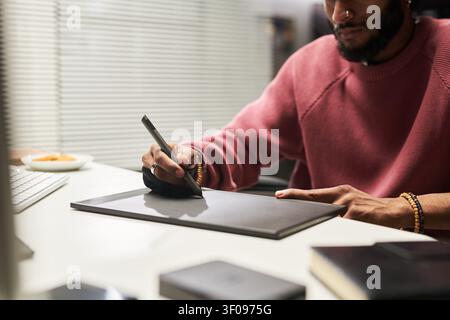 Man Using Graphic Tablet for Digital Design Work Stock Photo
