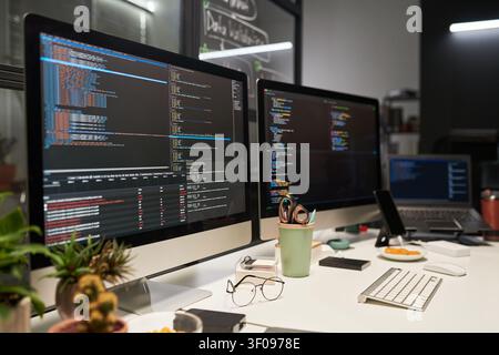 Software Development Workstation Displaying Code for Tech Team Stock Photo
