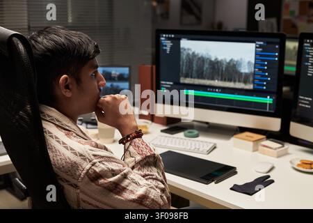 Asian Man Editing Video Content at Desktop for Creative Marketing Stock Photo