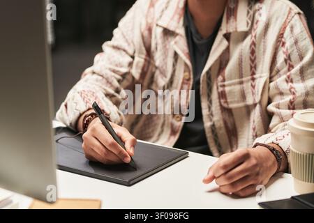 Man Using Graphics Tablet for Digital Design Work Stock Photo
