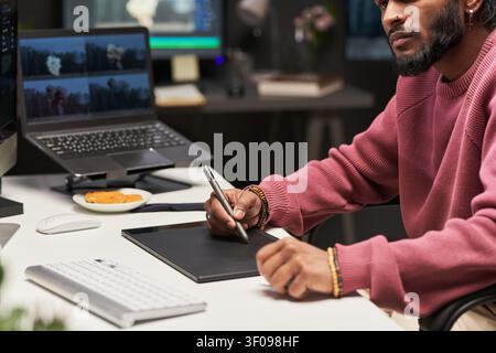 Man Using Graphics Tablet for Creative Remote Work Stock Photo
