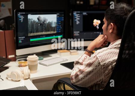 Man Editing Video Content on Desktop for Creative Workflow Stock Photo