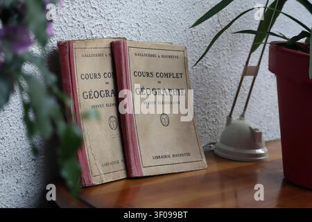 Lardy, France - July 19, 2021: Vintage French geography textbooks on a wooden table in Lardy, Ile de France, France Stock Photo