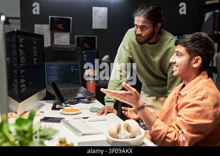 Men Reviewing Software Code in Office Collaboration Stock Photo